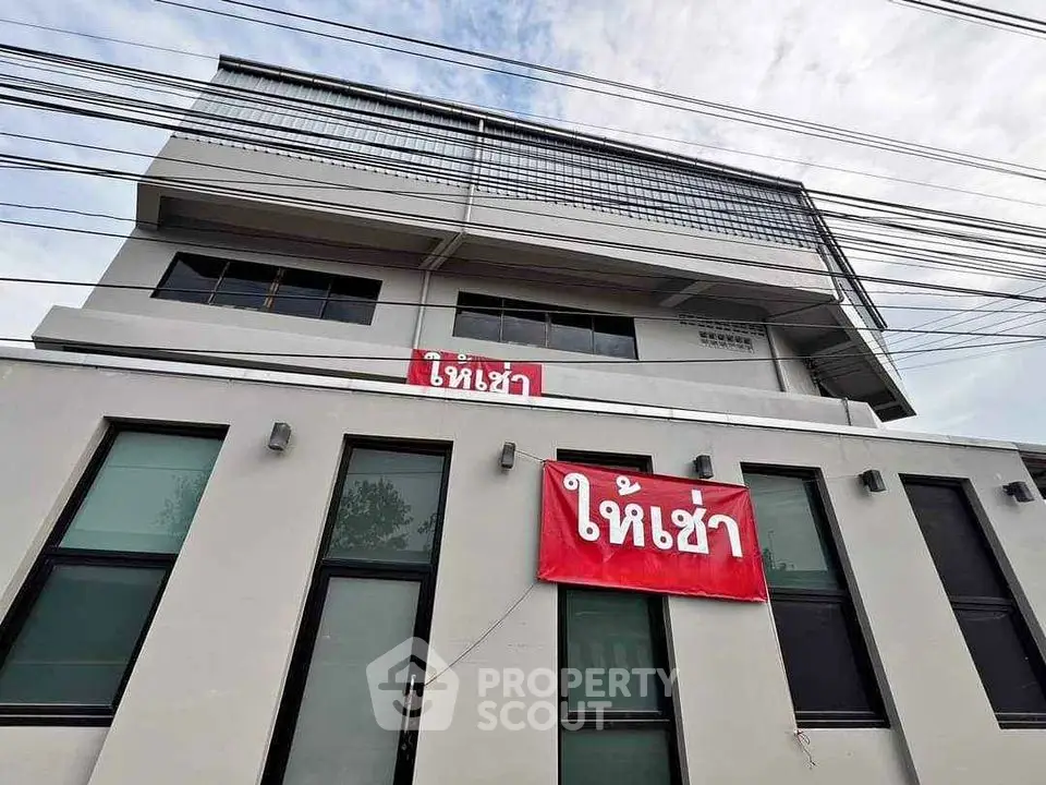 Modern commercial building for rent with large windows and contemporary design.