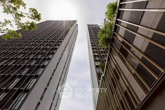 Stunning architectural view of modern high-rise buildings with lush greenery.
