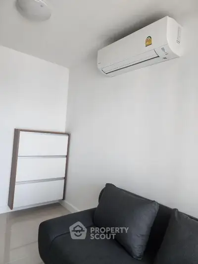 Modern minimalist living room with sleek air conditioning unit and stylish furniture