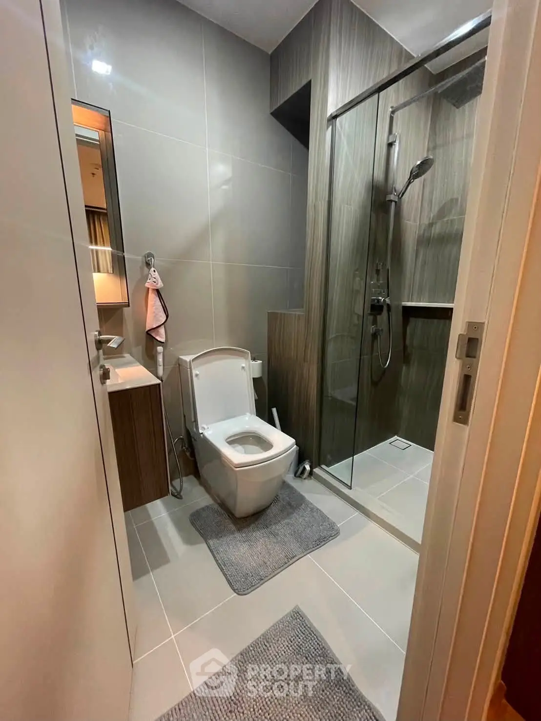 Modern bathroom with sleek design, featuring a glass shower and contemporary fixtures.