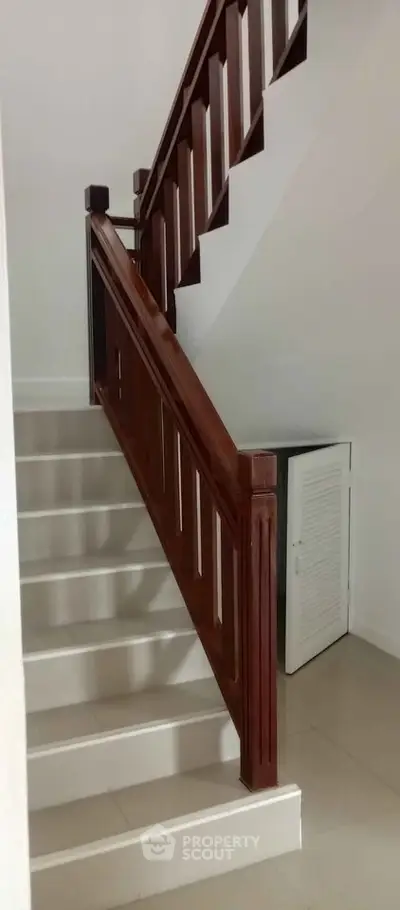 Elegant staircase with wooden railing in modern home interior