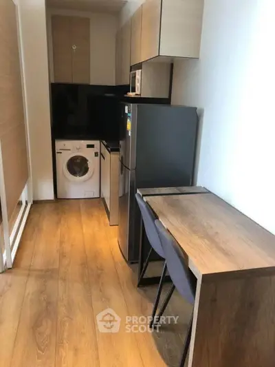Compact kitchen with modern appliances and wooden flooring