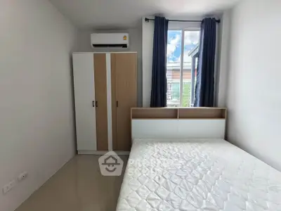 Modern bedroom with large window and air conditioning unit