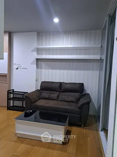 Cozy living room with brown sofa and modern coffee table, perfect for relaxation.