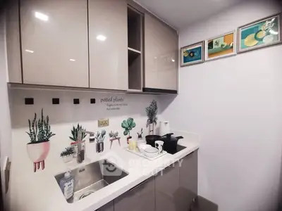 Chic modern kitchen with stylish cabinetry and artistic wall decor