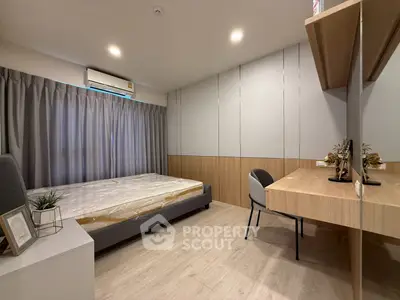 Modern bedroom with stylish desk and large window, perfect for comfort and productivity.