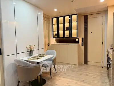 Modern dining area with elegant table setting and built-in storage in a cozy apartment.