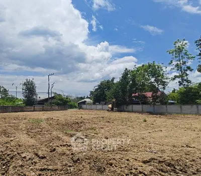 Expansive vacant land under a clear blue sky, ideal for development opportunities.