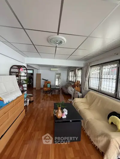 Spacious living room with wooden flooring and cozy furnishings