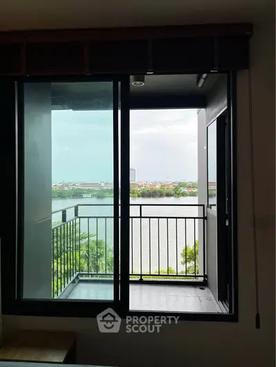Stunning balcony view overlooking serene river and lush greenery, perfect for relaxation and tranquility.
