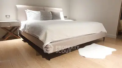 Luxurious bedroom with elegant decor and cozy ambiance, featuring a stylish bed and soft lighting.