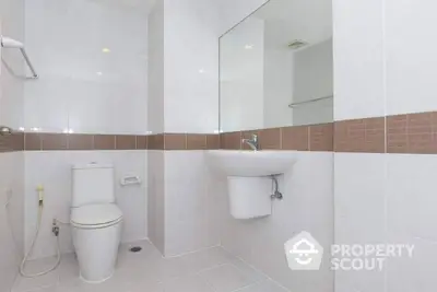 Modern bathroom with sleek white fixtures and elegant tile design