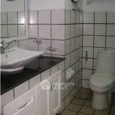 Modern bathroom with tiled walls and sleek fixtures