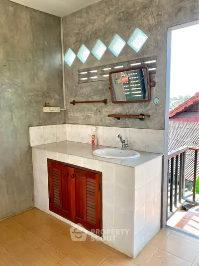 Charming bathroom with rustic wooden vanity and unique geometric window design.