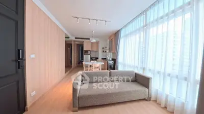 Modern living room with cozy sofa and large windows in a stylish apartment