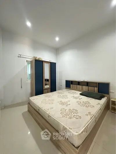 Spacious bedroom with modern furnishings and ample natural light, perfect for relaxation and comfort.