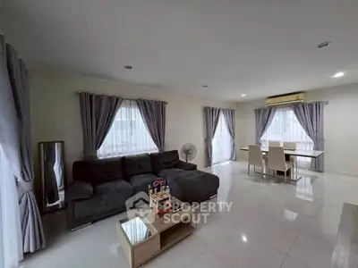Spacious living room with modern furniture and large windows for natural light.