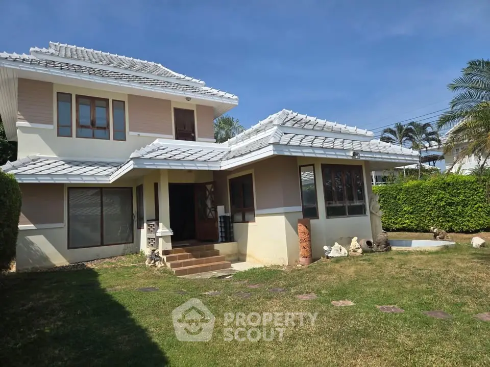 Charming two-story house with manicured lawn and modern architecture in a serene neighborhood.