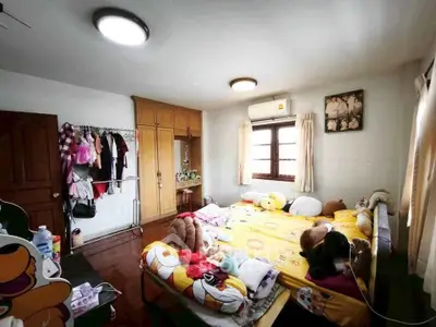 Cozy bedroom with wooden wardrobe and playful decor, perfect for a child's retreat.