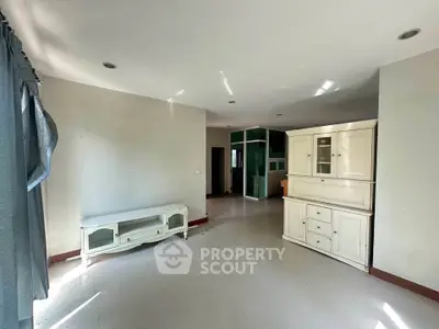 Spacious living room with elegant white furniture and ample natural light