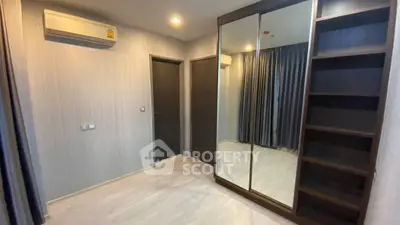 Modern bedroom with mirrored wardrobe and air conditioning in a stylish apartment.