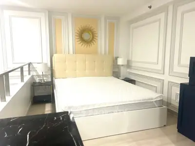 Luxurious bedroom with elegant decor and plush bed in modern apartment