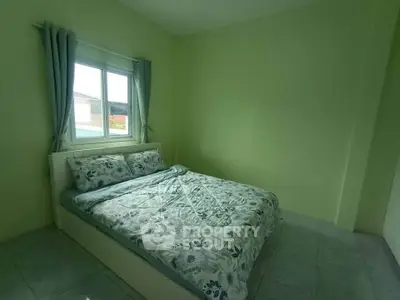 Cozy bedroom with floral bedding and natural light