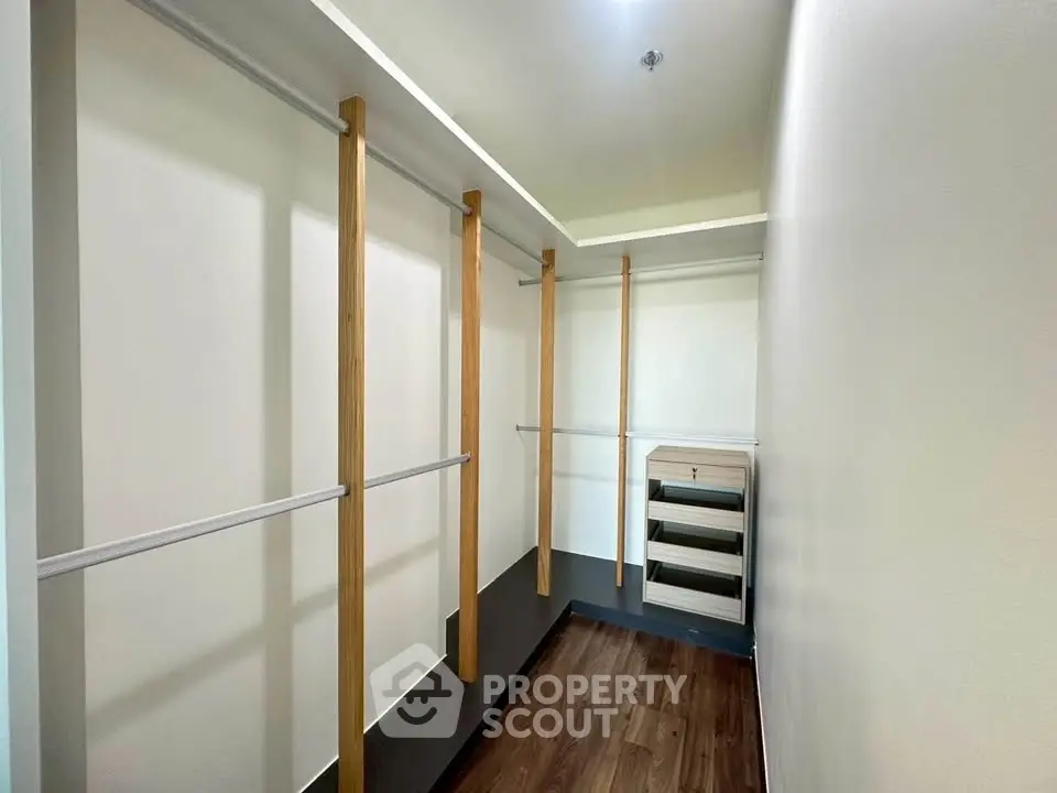 Spacious walk-in closet with modern wooden shelving and ample storage space.