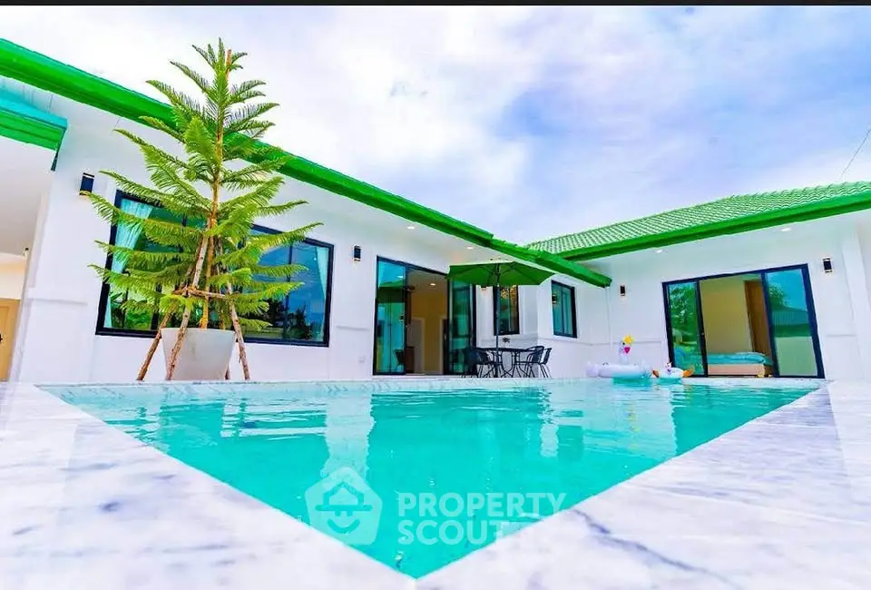 Luxurious modern villa with private pool and green roof, perfect for relaxation.