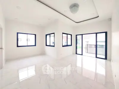 Spacious modern living room with large windows and elegant ceiling design