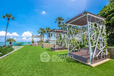 Luxurious beachfront garden with modern cabanas and stunning ocean view