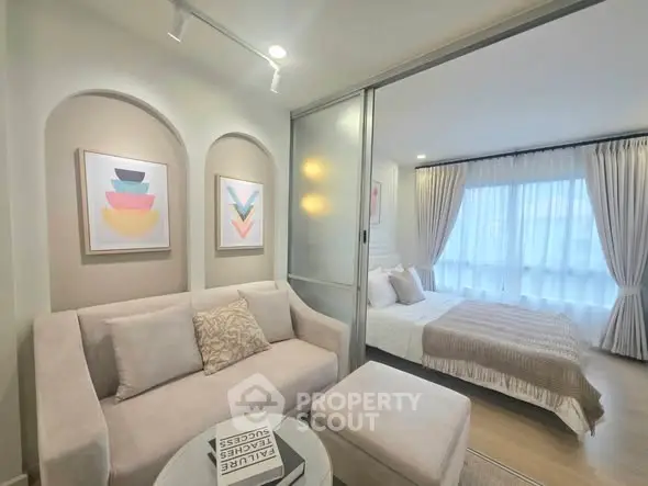 Modern studio apartment with cozy living area and elegant bedroom