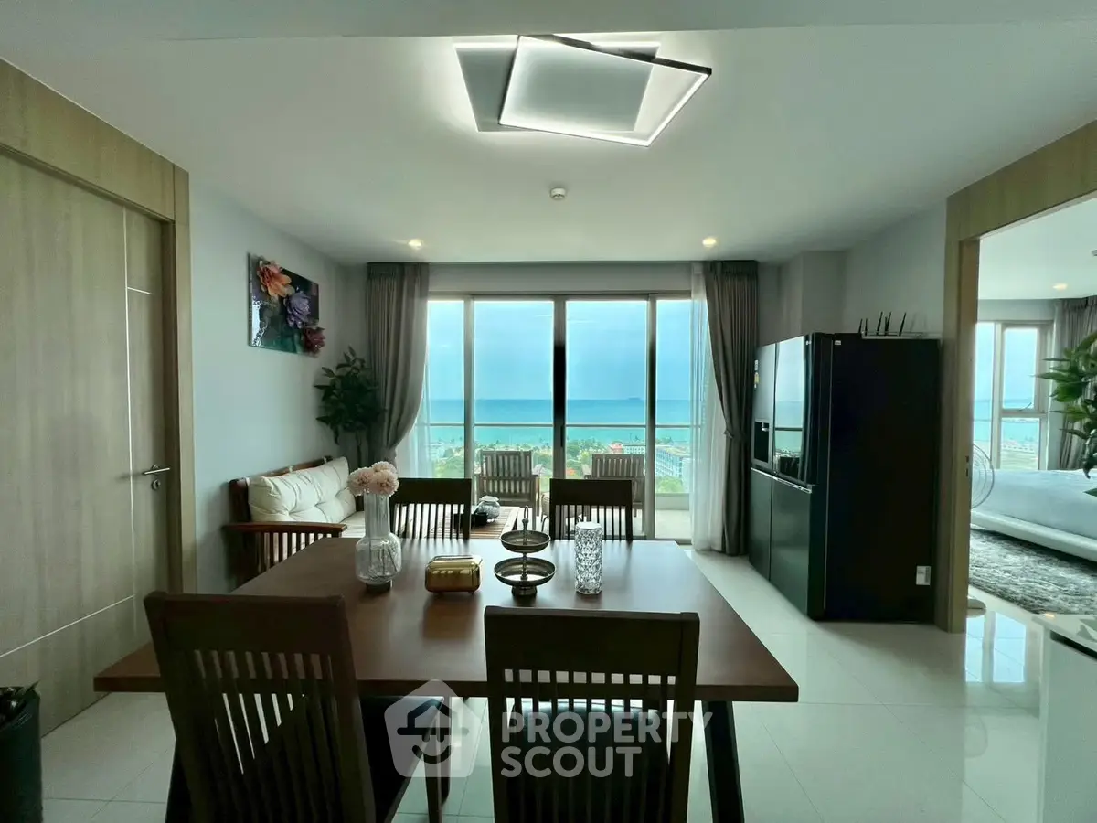 Stunning beachfront apartment with modern dining area and ocean view, perfect for luxury living.
