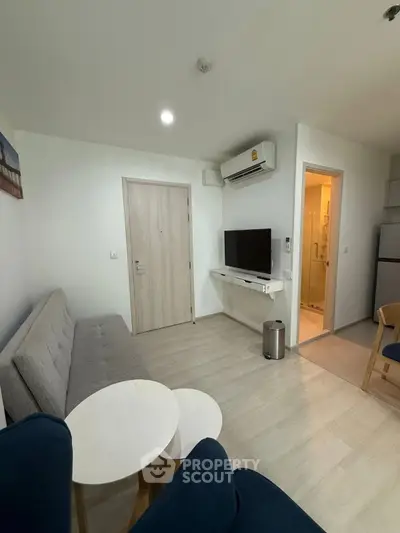 Modern living room with sleek furniture and air conditioning in a cozy apartment.