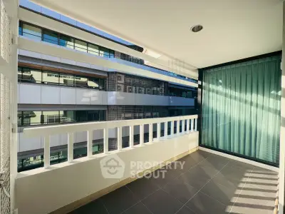 Spacious balcony with modern design and city view, perfect for relaxation and enjoying the urban landscape.