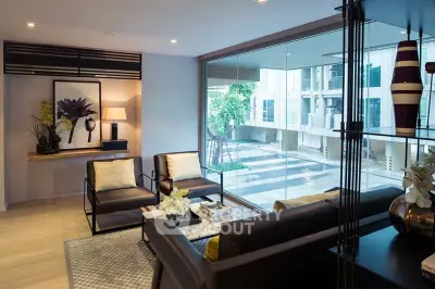 Modern living room with large window offering a view of contemporary architecture and stylish interior decor.