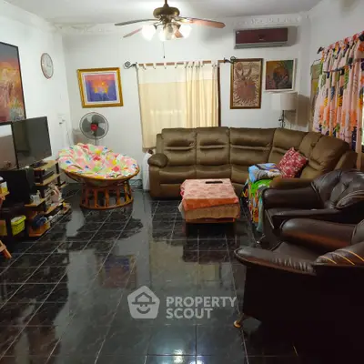 Spacious living room with cozy seating and stylish decor, perfect for family gatherings.