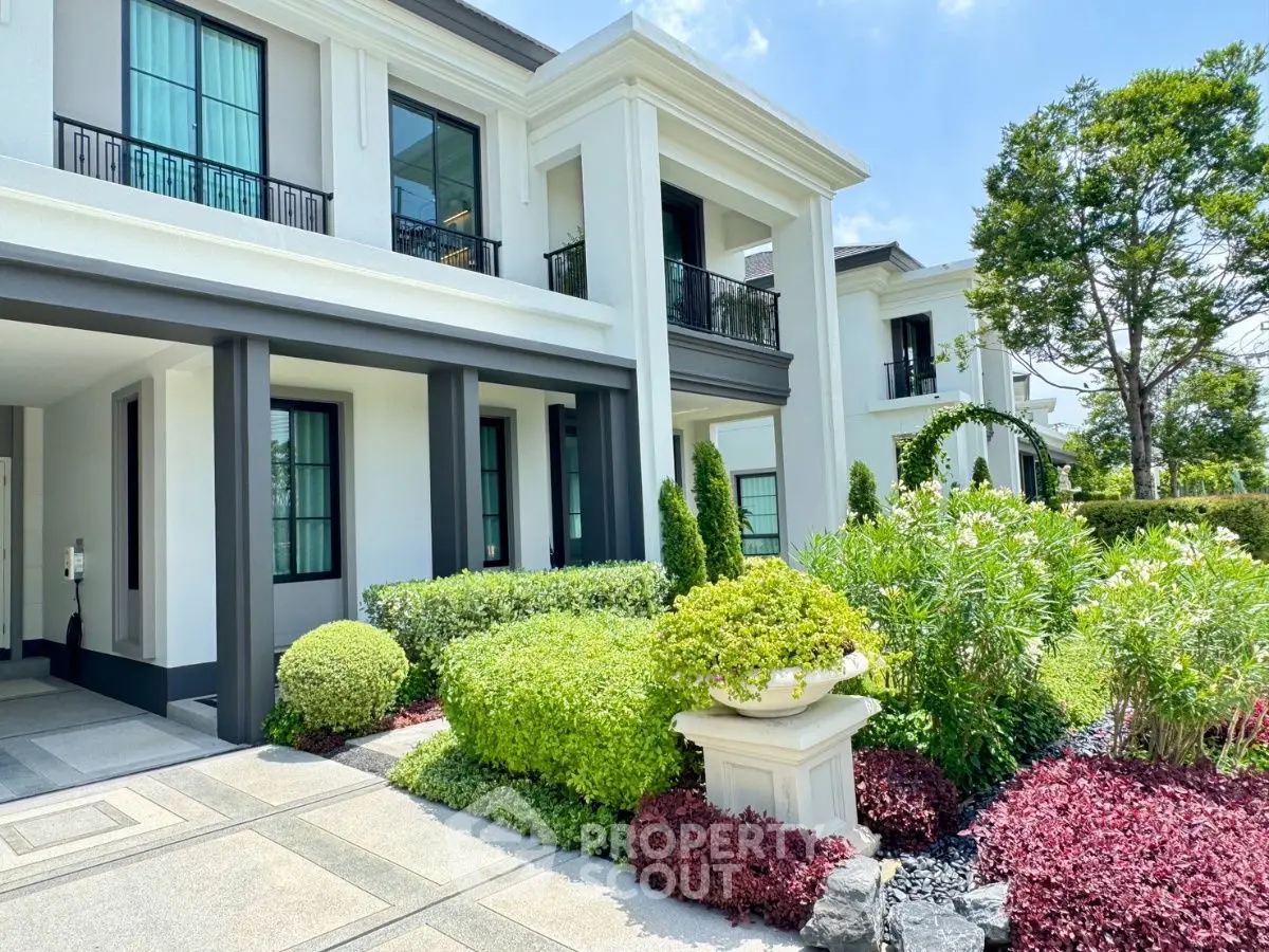 Luxurious modern home exterior with lush garden and elegant architecture.