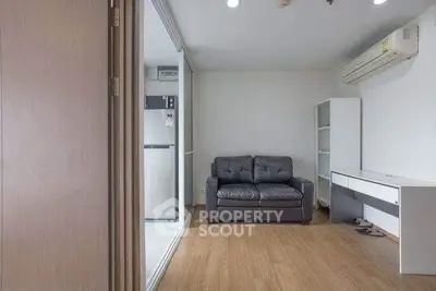 Modern living room with sleek furniture and air conditioning in a cozy apartment.