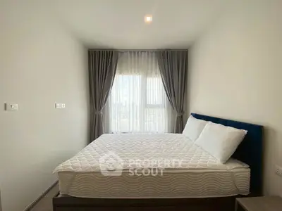 Modern bedroom with large window and elegant curtains in a stylish apartment.