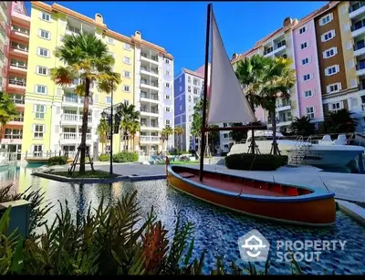 Vibrant apartment complex with colorful buildings and a unique boat-themed pool area.