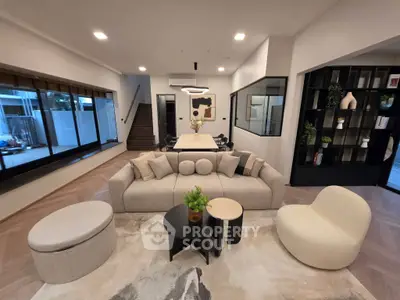 Spacious modern living room with stylish furniture and large windows, perfect for relaxation and entertaining.
