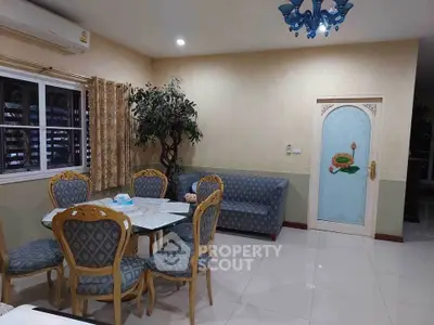 Charming living room with elegant dining set and cozy sofa, perfect for family gatherings.