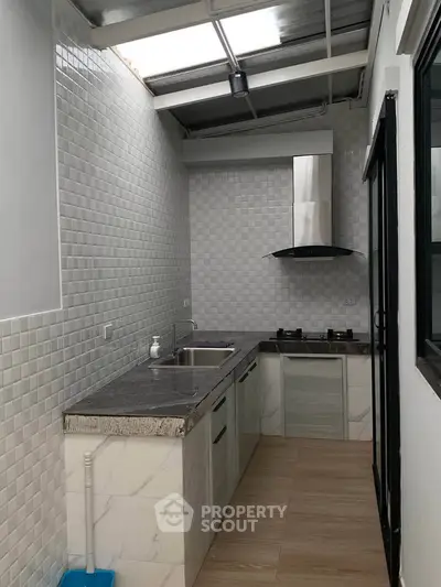 Modern kitchen with sleek design and gas stove in a compact layout