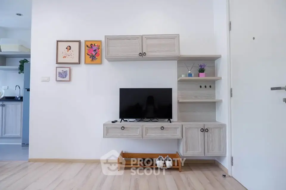 Modern living room with stylish TV cabinet and wooden flooring, perfect for cozy family gatherings.
