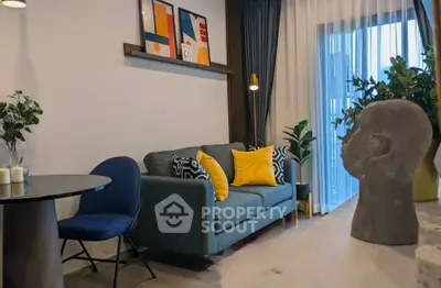 Stylish modern living room with cozy sofa, vibrant decor, and large window for natural light.