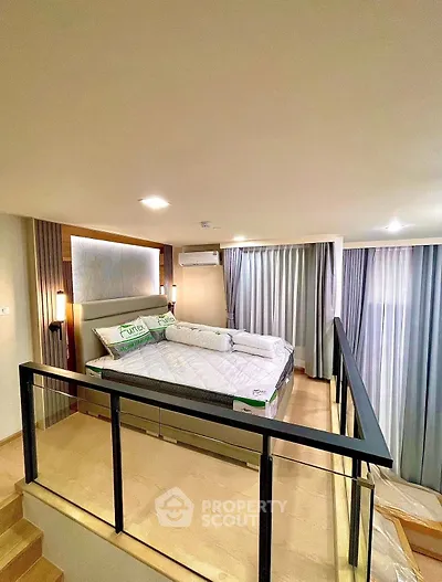 Modern loft bedroom with stylish decor and ample natural light
