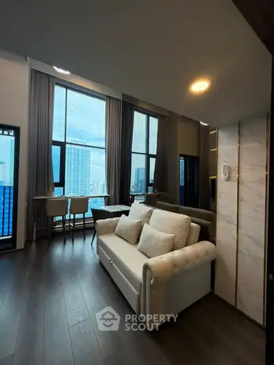 Luxurious high-rise living room with stunning city view and elegant furnishings.