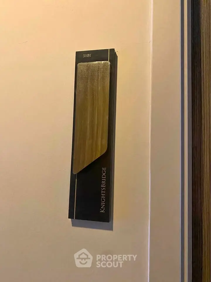 Stylish apartment door number plaque in modern building