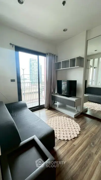 Modern living room with balcony view, sleek furniture, and stylish decor